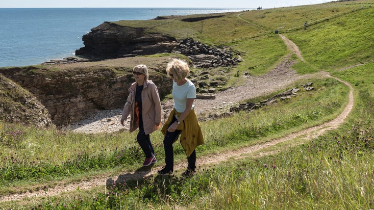 Visitors walking along the coastpath at Souter Lighthouse and The Leas, Tyne & Wear